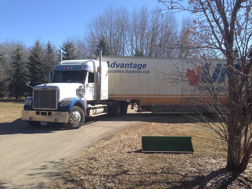 A white truck is parked on a dirt road