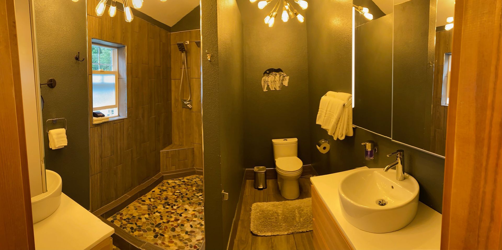A bathroom with a toilet , sink , and shower.