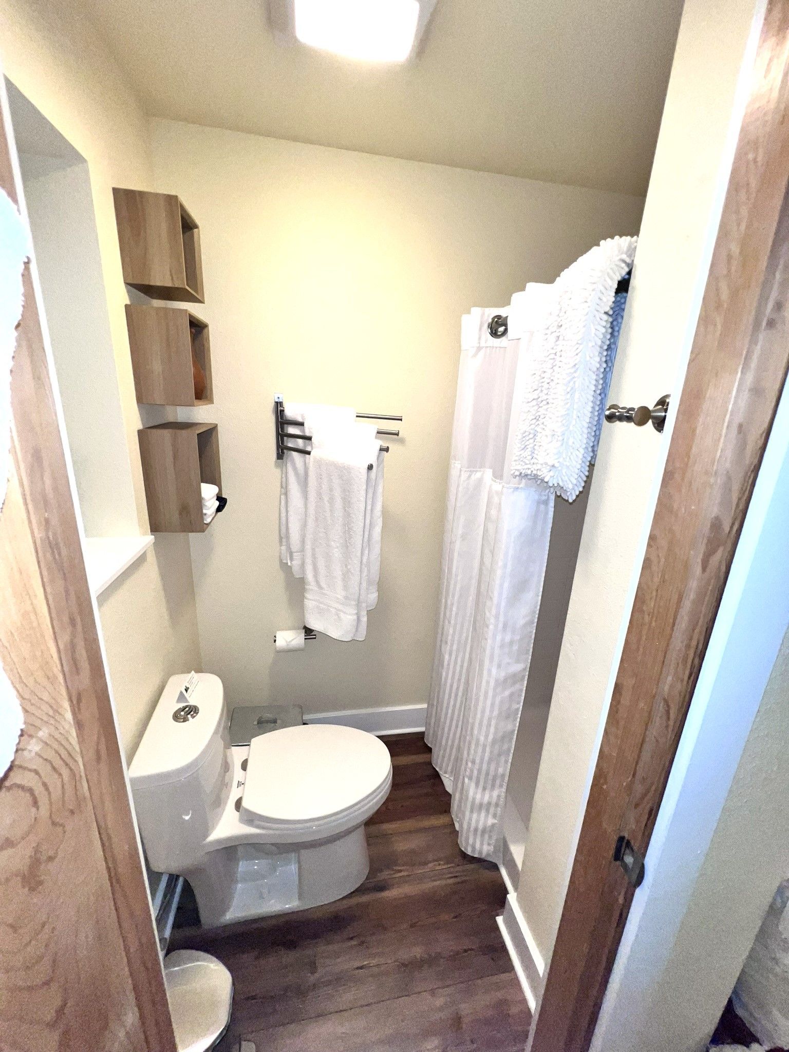 A bathroom with a toilet and a shower curtain