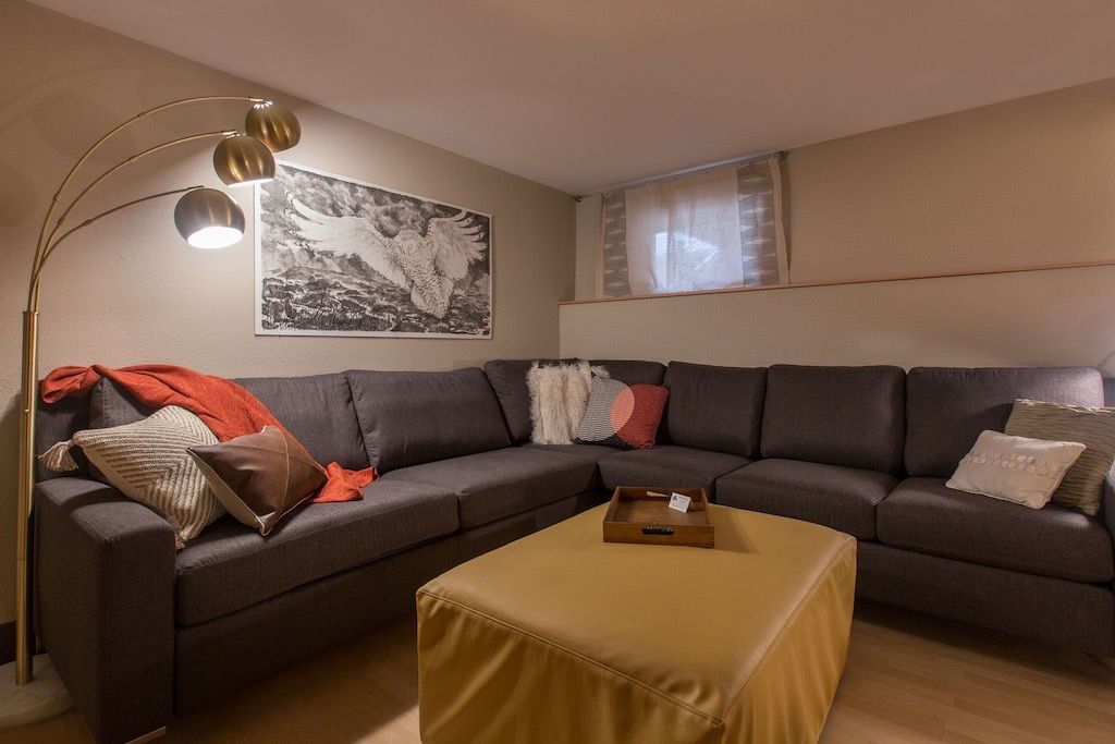 A living room with a large sectional couch and a coffee table.