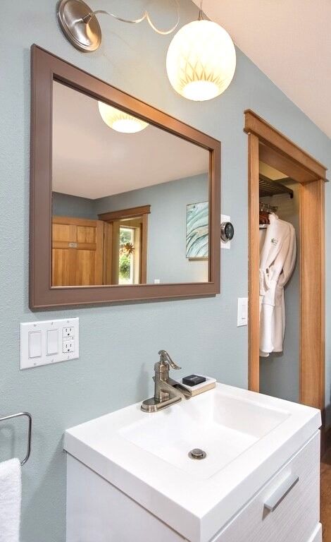 A bathroom with a sink and a large mirror