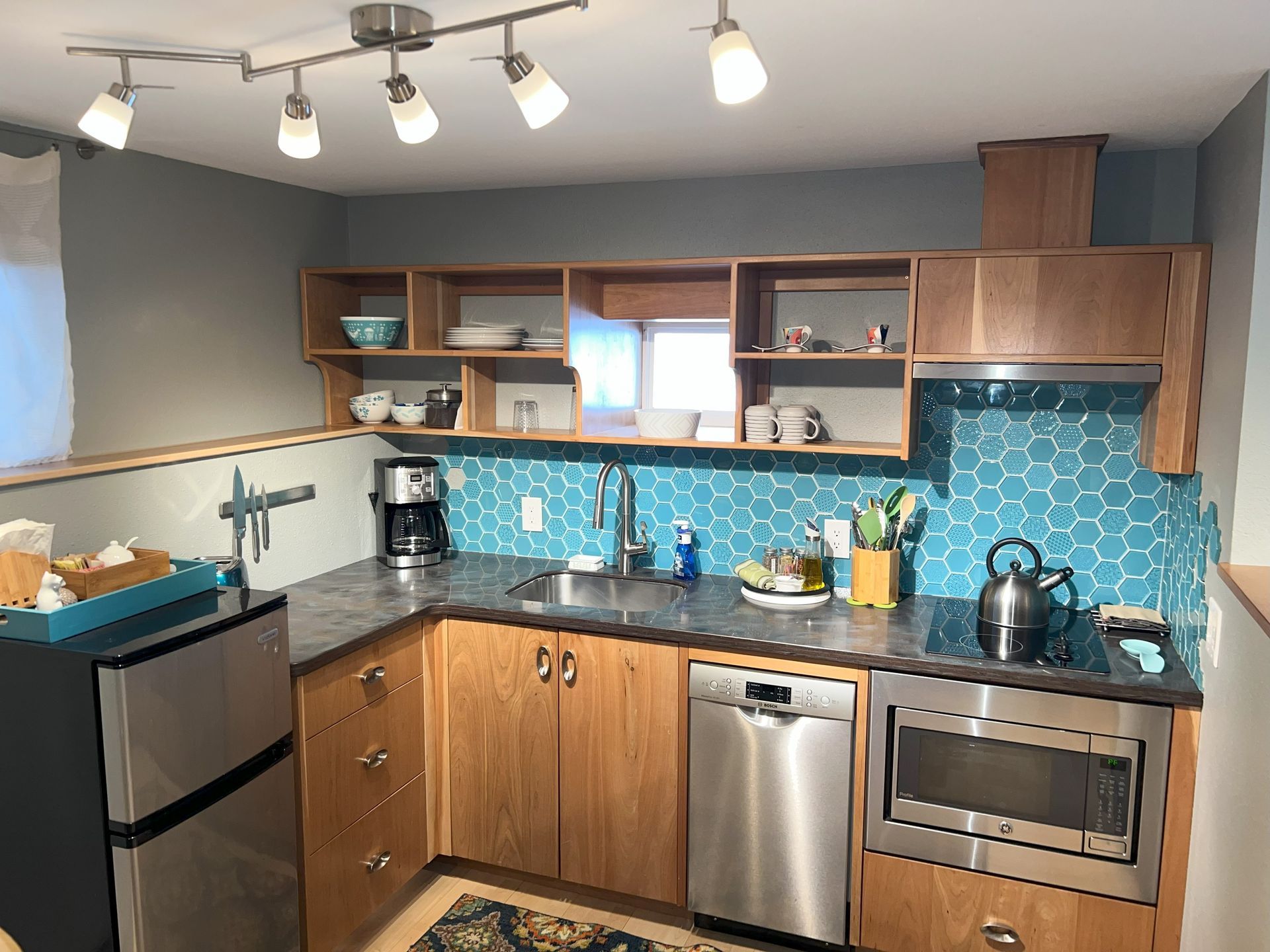 A kitchen with stainless steel appliances and wooden cabinets