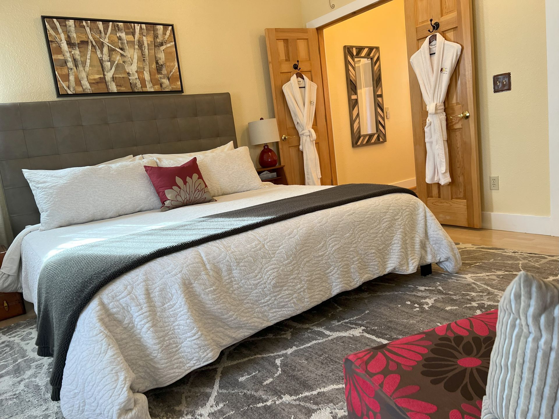 A bedroom with a king size bed and a rug