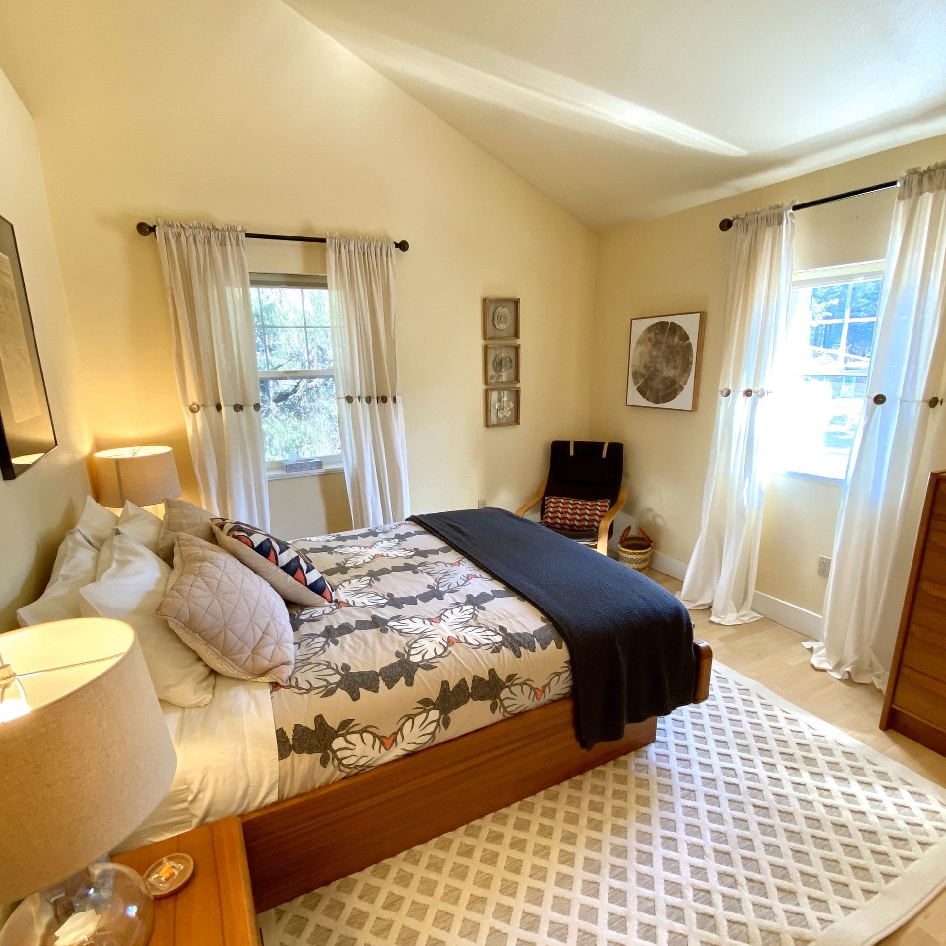 A bedroom with a large bed and a rug