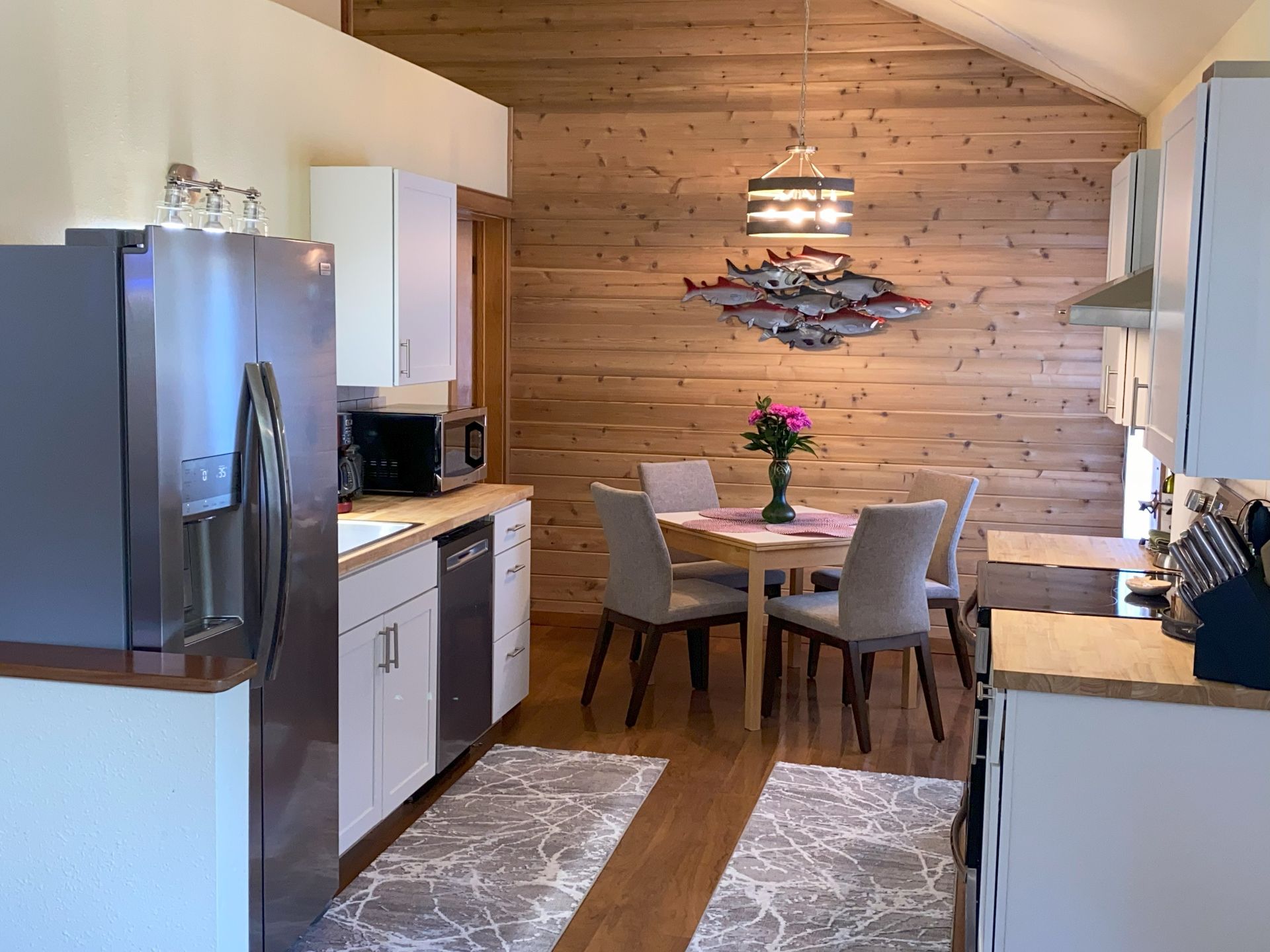 A kitchen with a table and chairs and a refrigerator.