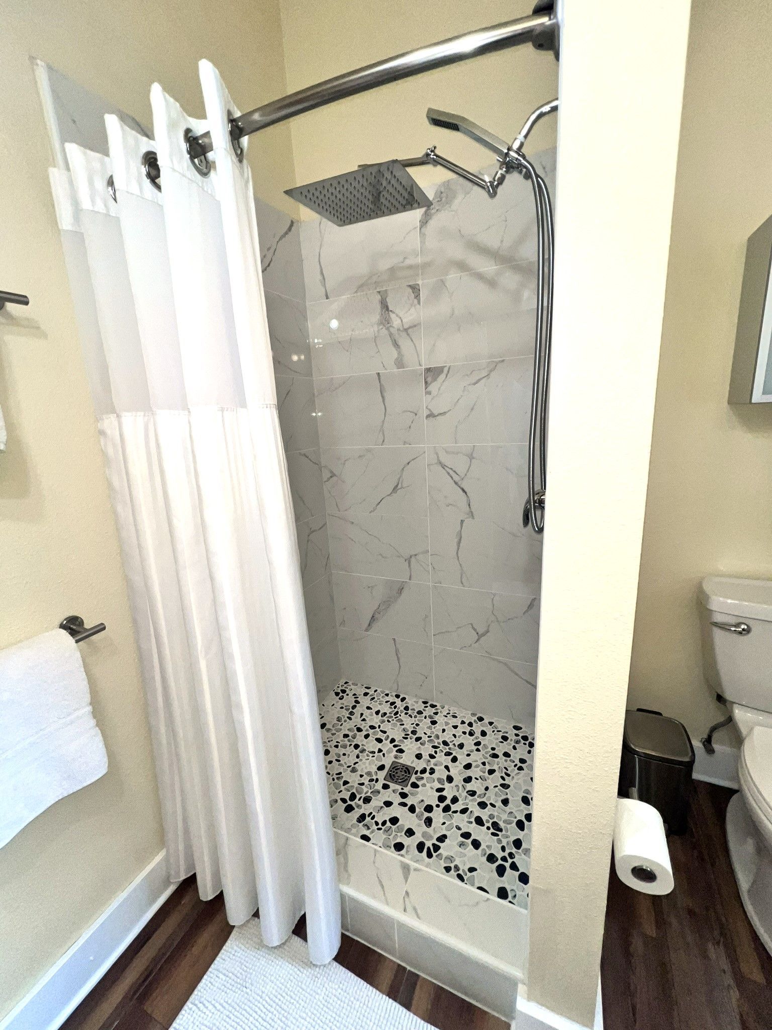 A bathroom with a shower and a toilet.