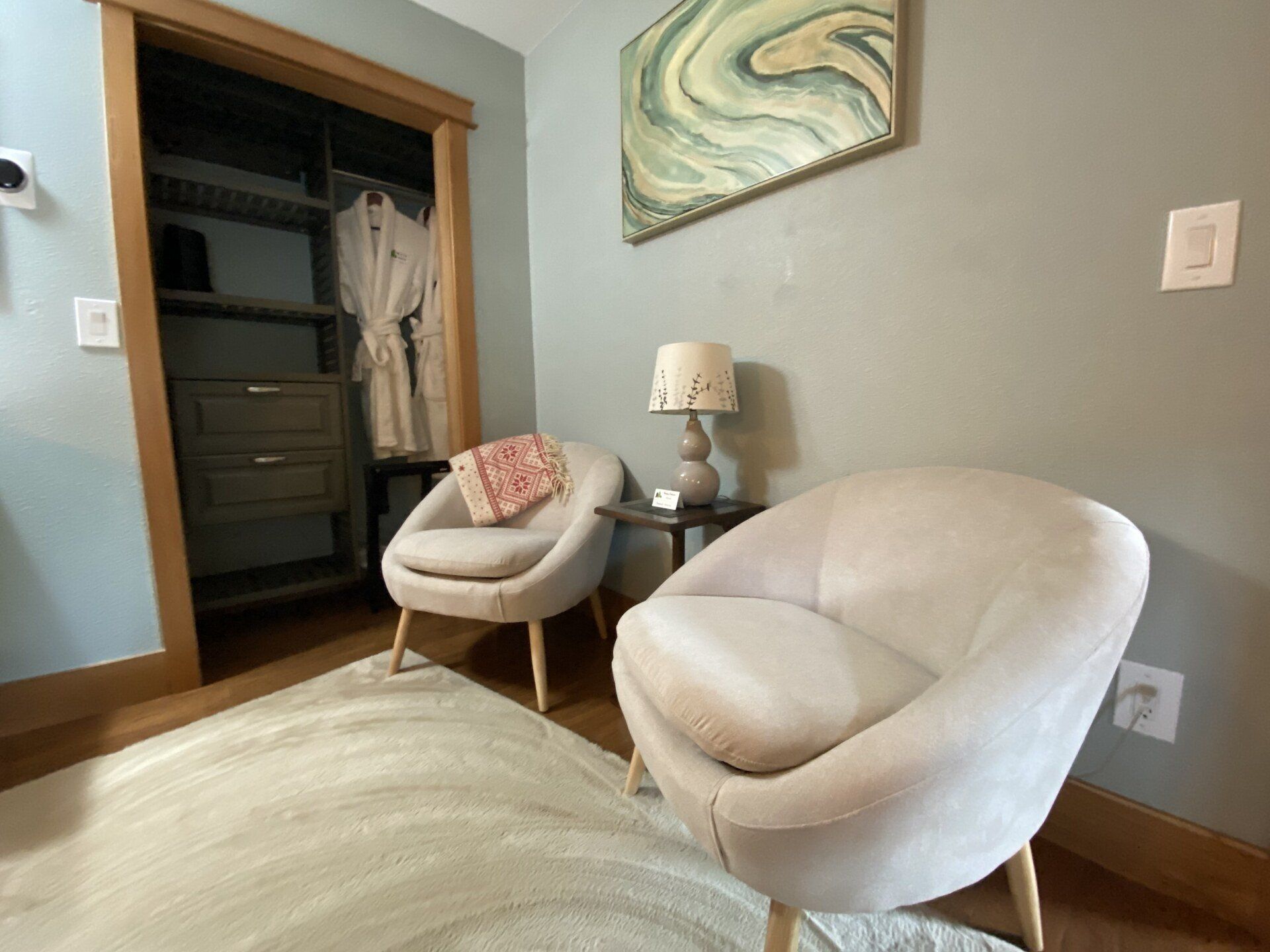 Mt. Adair deluxe double room in Bell In The Woods B&B in Alaska. Two armchairs and a wardrobe.