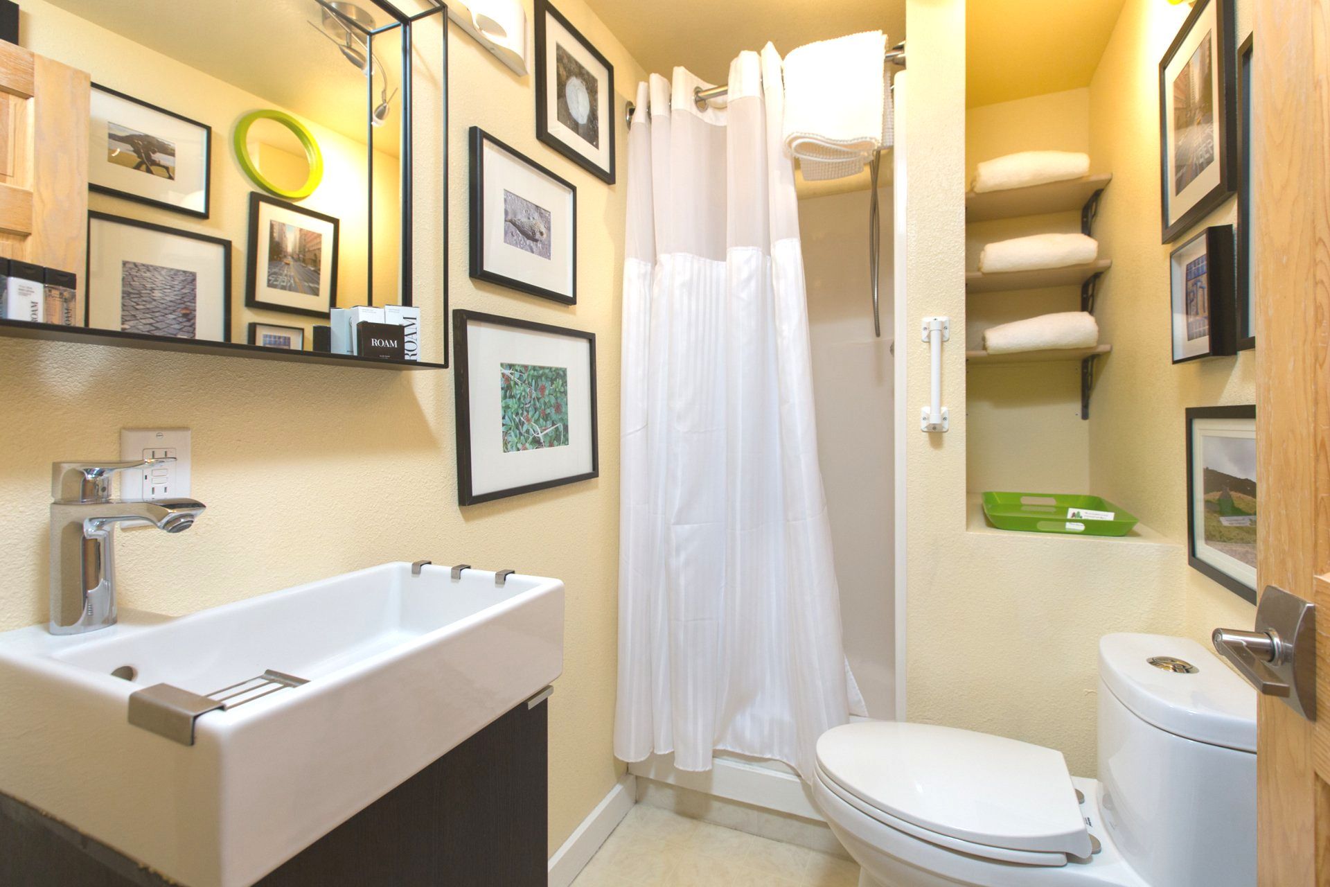 A bathroom with a toilet a sink and a mirror