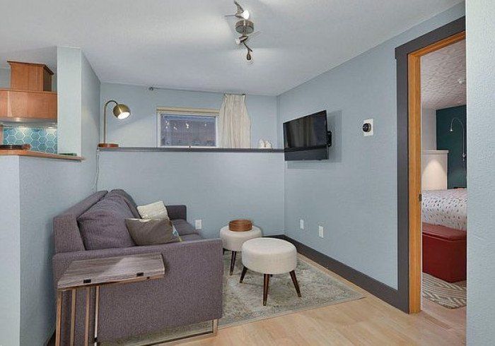 Mt. Eva 1 bedroom apartment in Bell In The Woods B&B in Alaska. Seating area. Grey sofa.