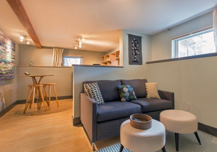 Mt. Eva 1 bedroom apartment in Bell In The Woods B&B in Alaska. Seating area. Grey sofa.