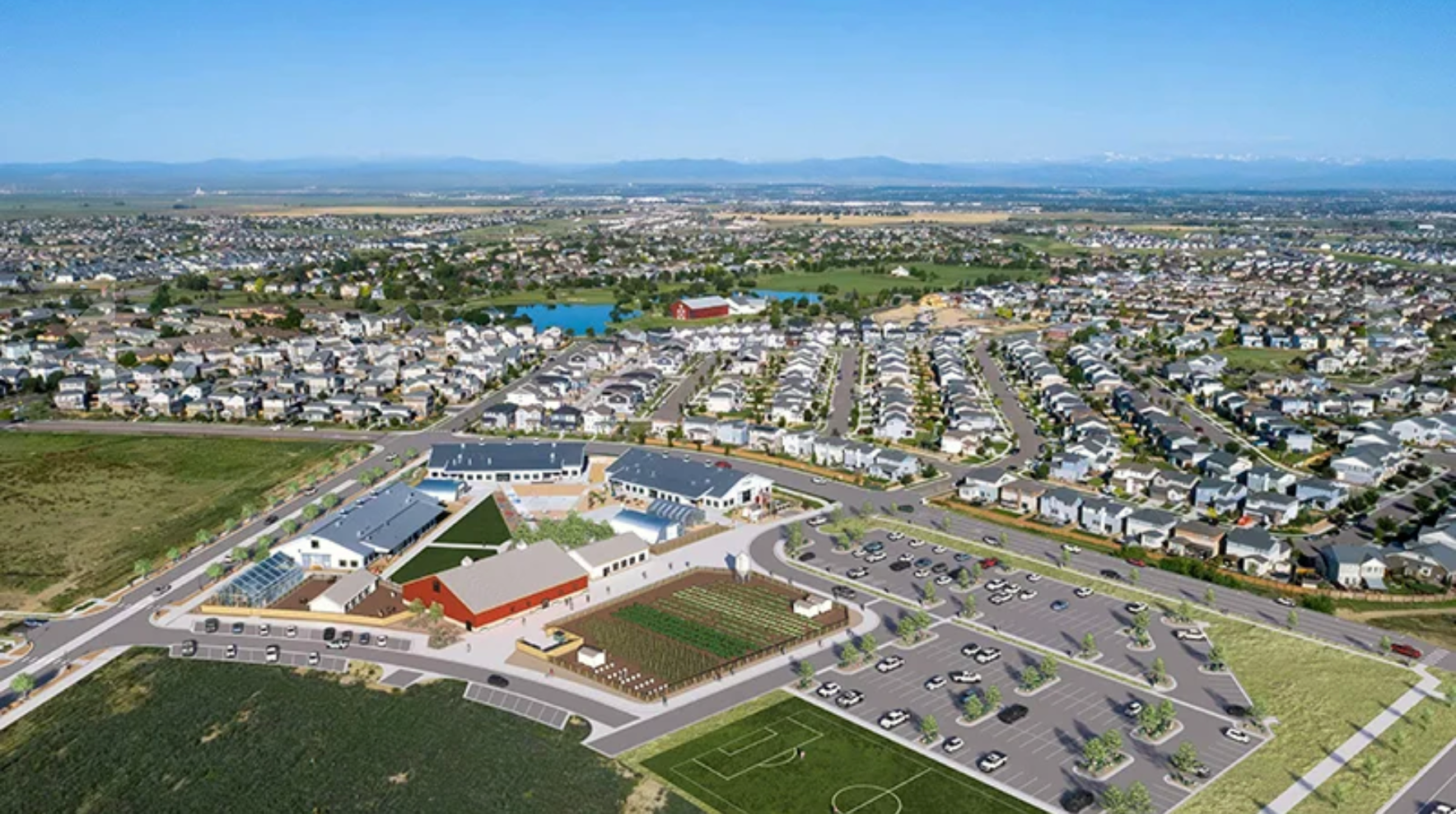 Aerial view of a suburban neighborhood with rows of houses, a school complex in the foreground.