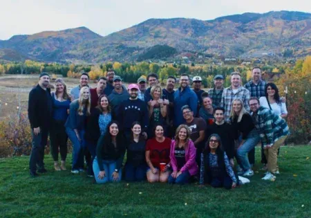 Group picture of Terracina Design team in front of a beautiful mountain scene.
