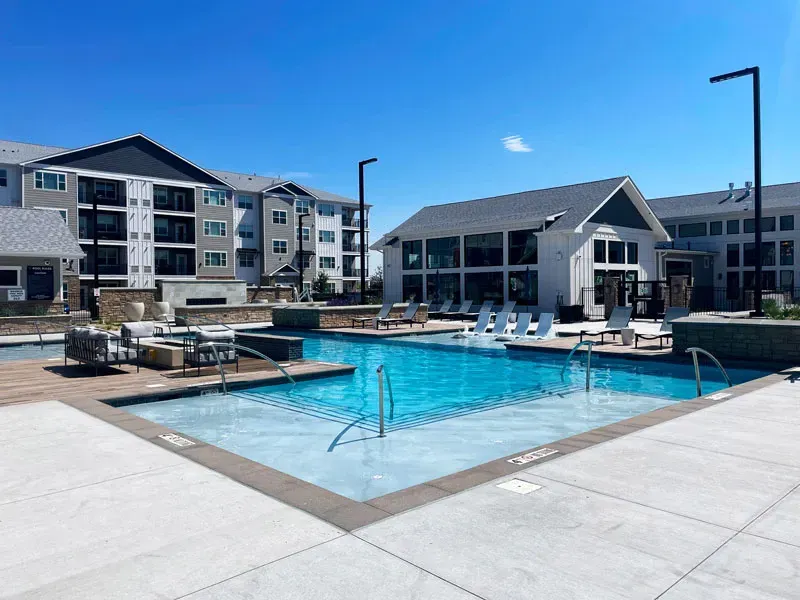 Modern apartment complex with a spacious outdoor pool area in Denver, CO.