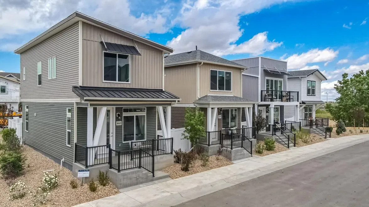 Row of modern two-story houses with porches and landscaped front yards.