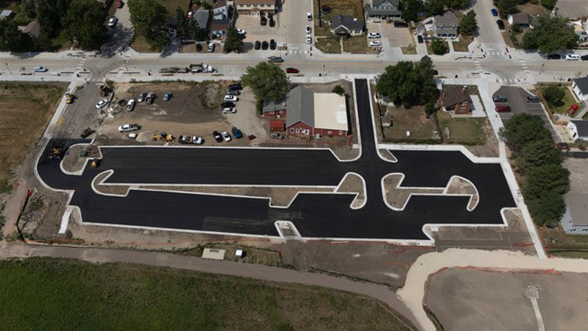 Aerial view of a newly paved black asphalt parking lot