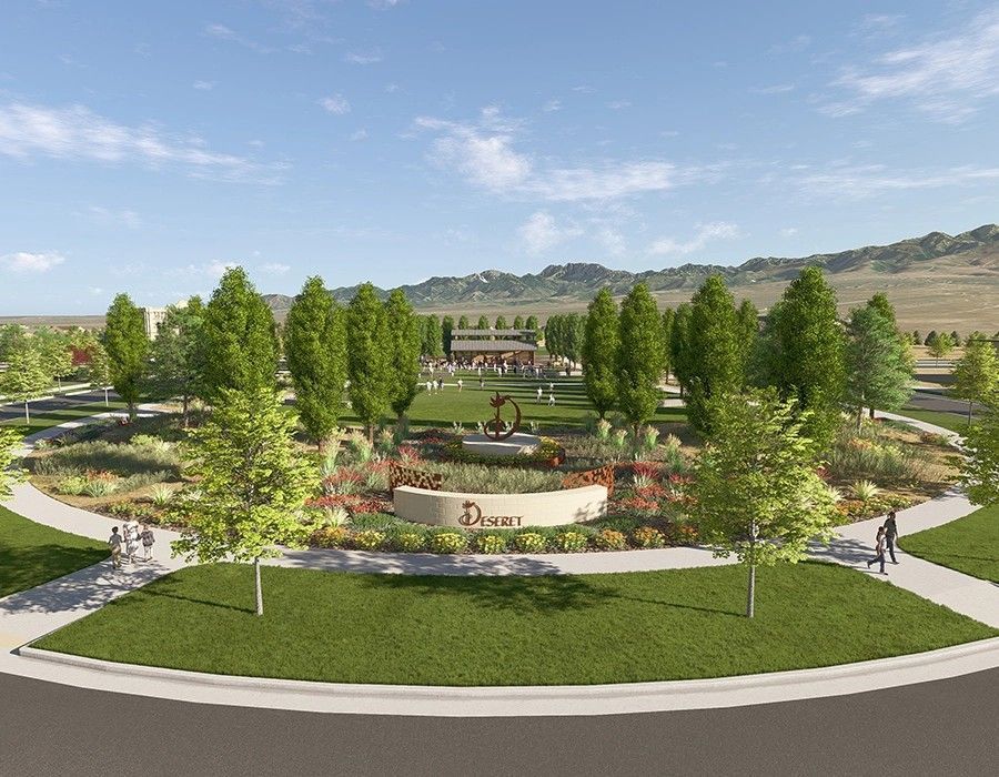 Landscaped park in Deseret with central monument, colorful flowers, and mountain.