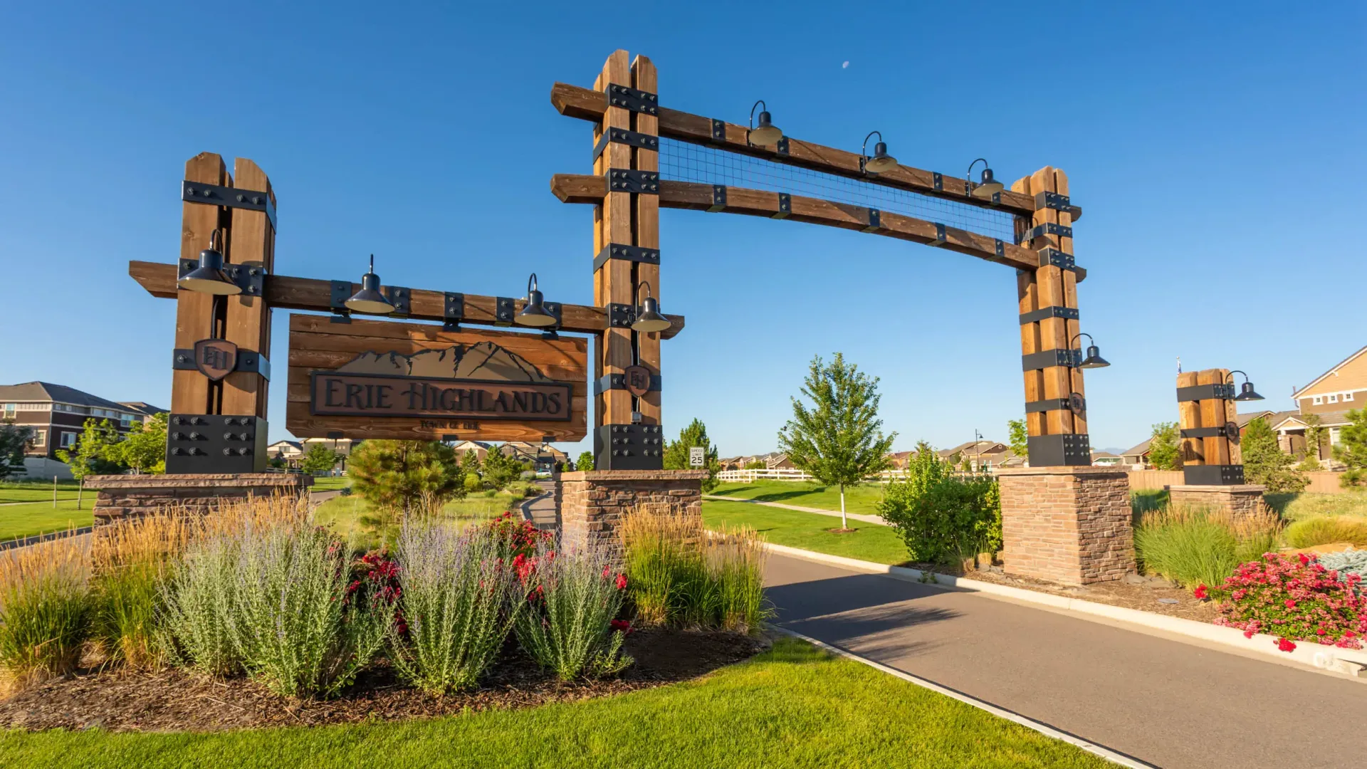 Wood and stone entrance sign for Erie Highlands community.