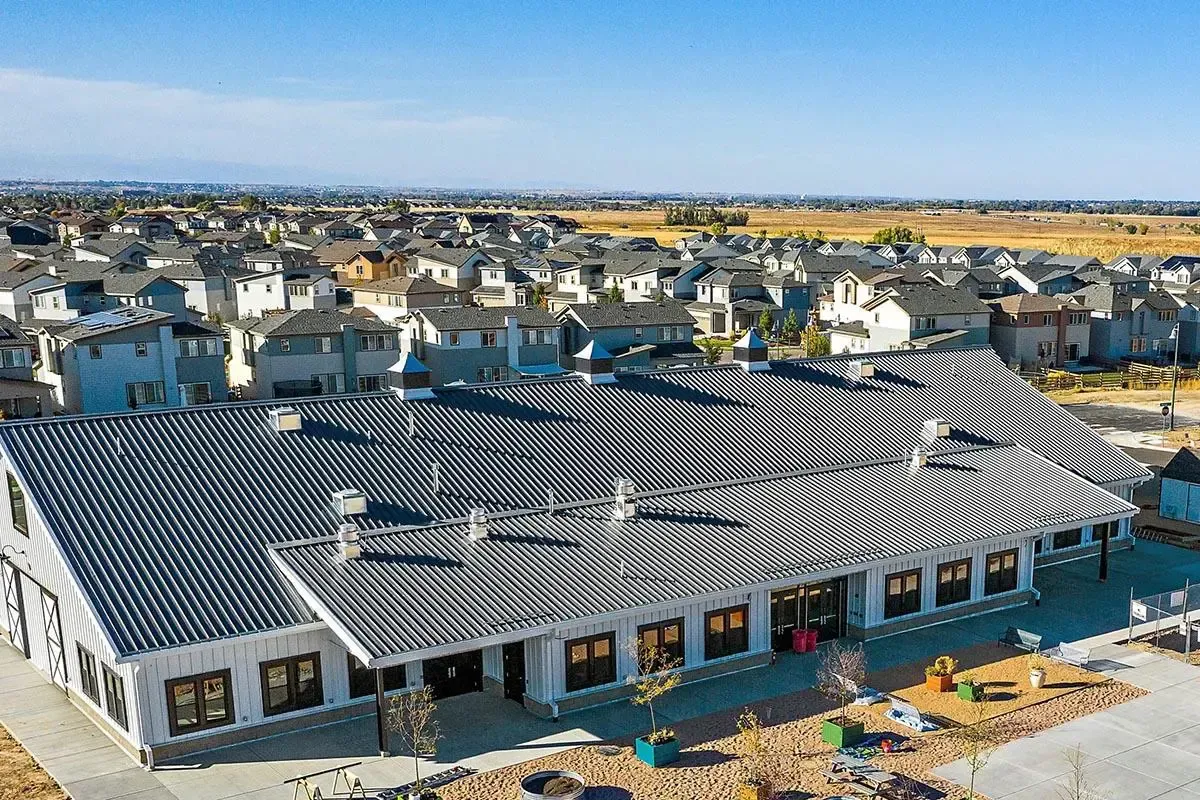 Aerial view of a large, grey-roofed building.
