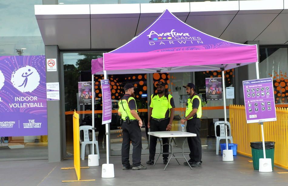 A Group Of Security Guards Are Standing In Front Of A Tent - Security in the Top End, NT