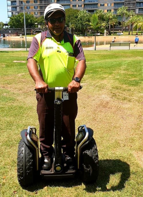 A Security Man Is Riding A Segway In A Park - Security in the Top End, NT