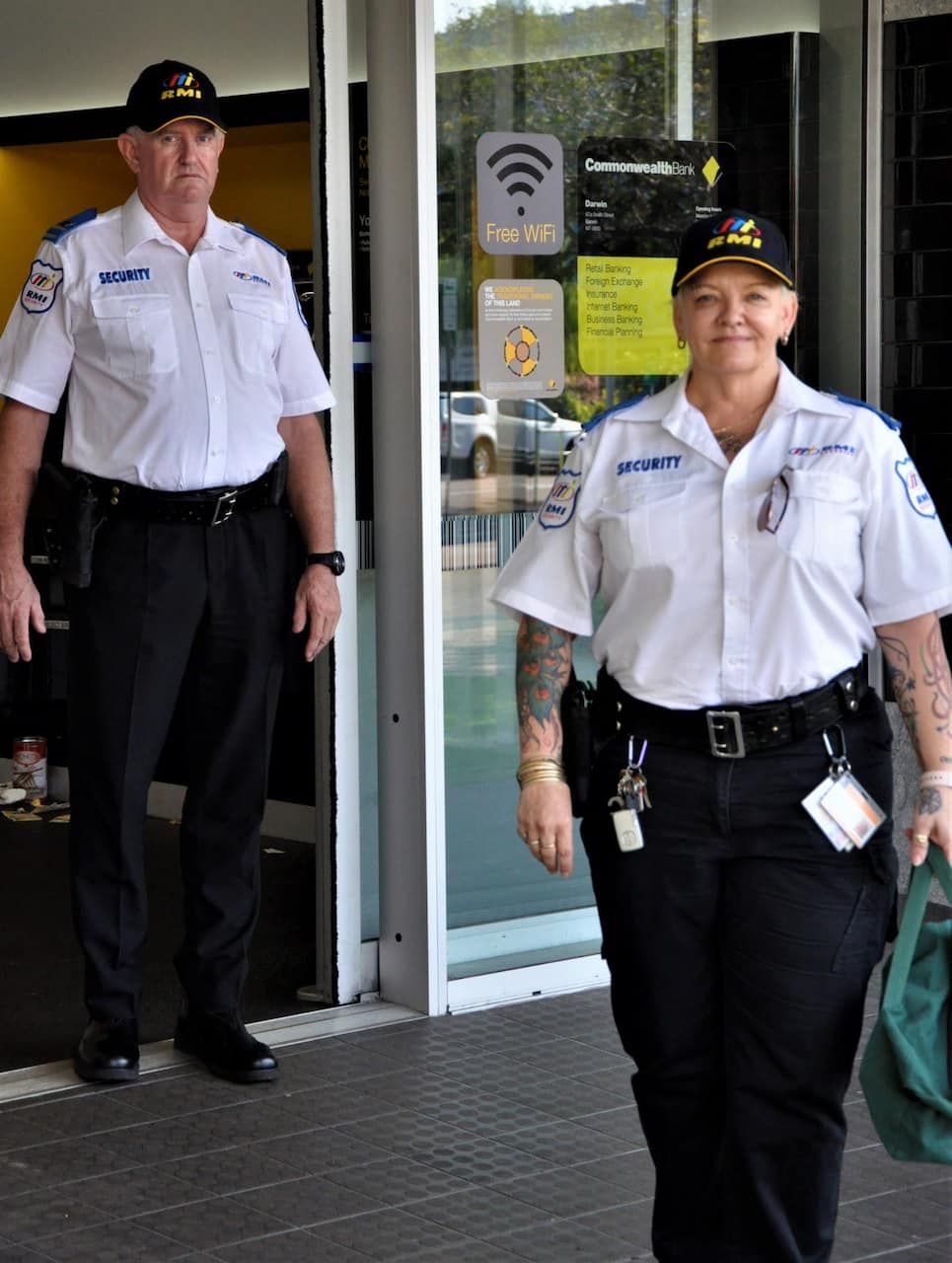 Two security guards standing infront of a bank after transit - Secure Cash in Transit in Darwin, NT