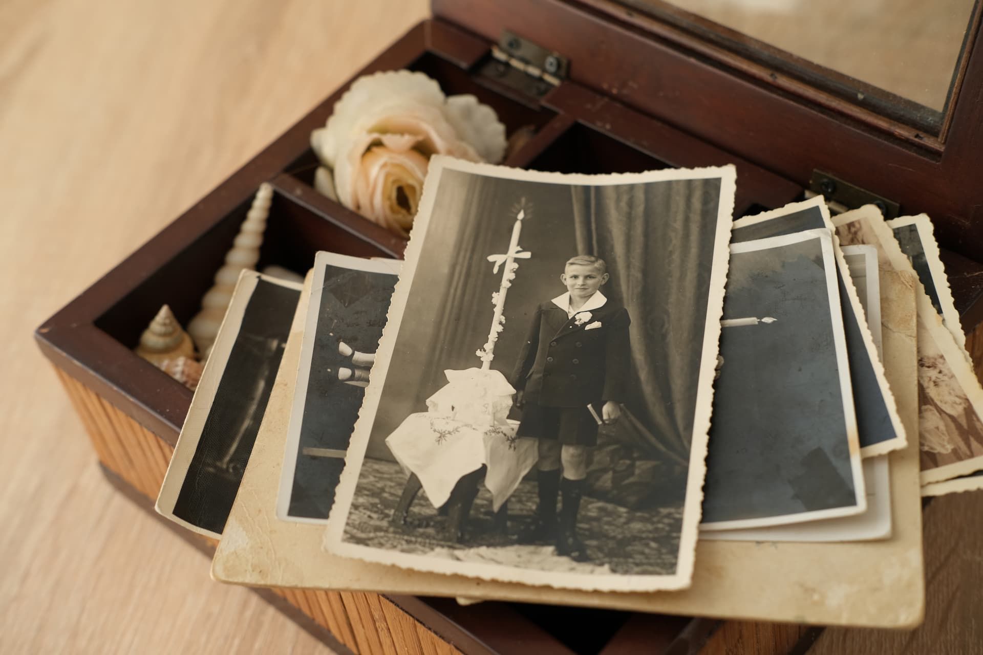 Two people on a white couch looking through a photo album with landscape pictures