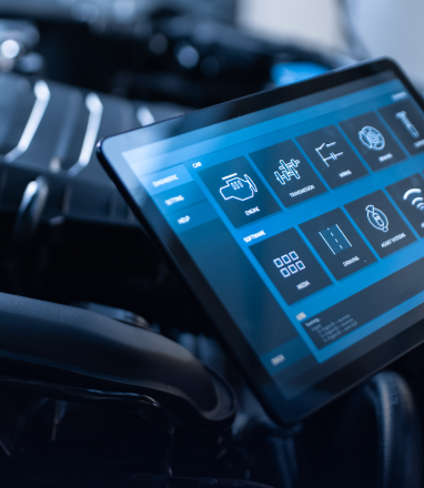 Blue car dashboard touchscreen with app icons in a dark interior