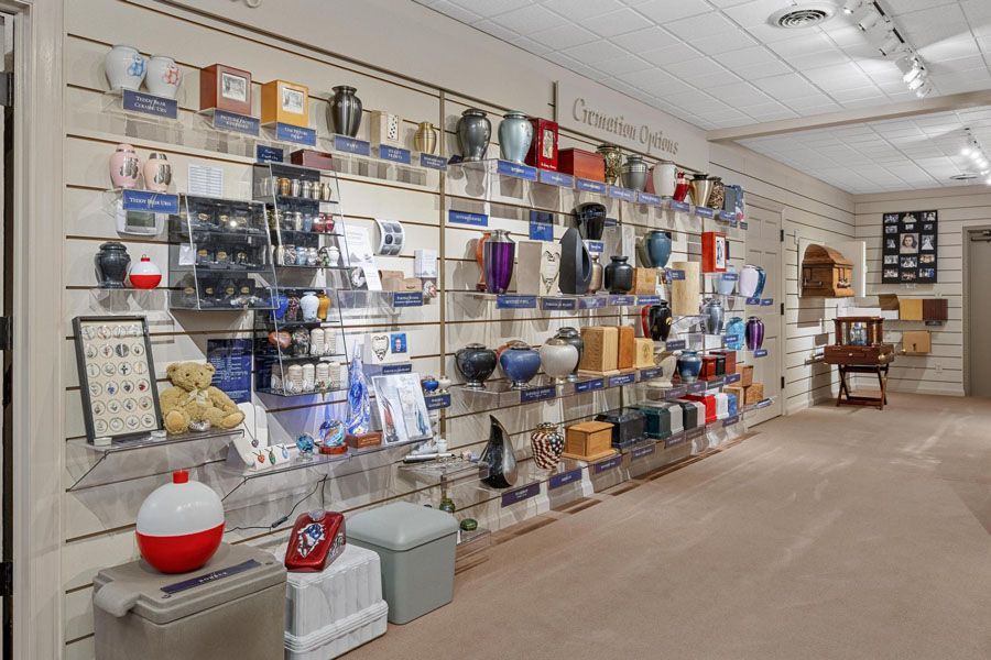 Store aisle with wall-mounted shelves of household goods and decor in a beige retail showroom