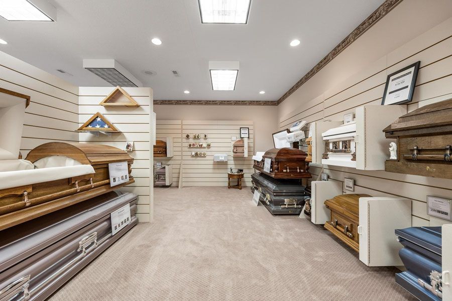 Showroom with mattresses, bunk beds, and furniture displayed along beige walls