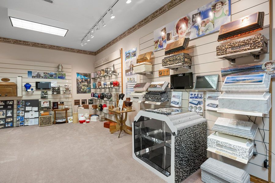 Bright showroom with shelves of folded linens, home goods, and appliances on display