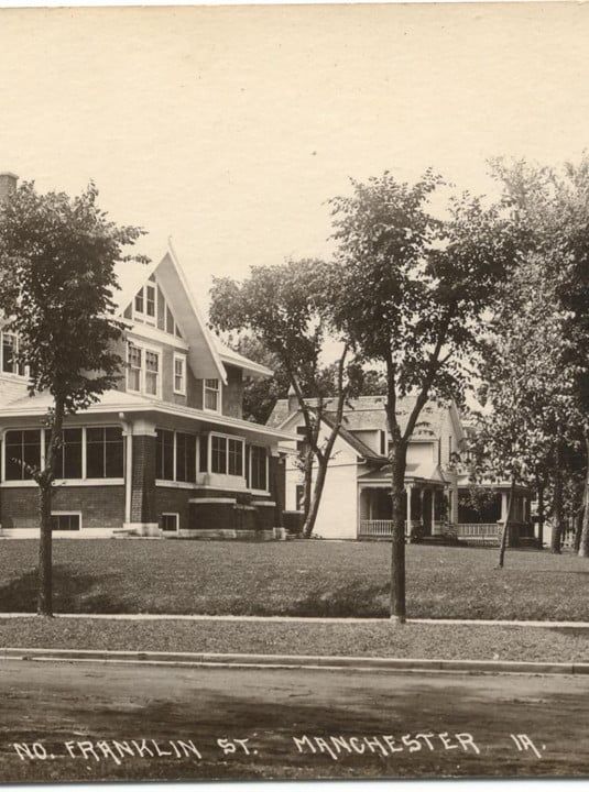 Historic house on Franklin St., Manchester, with trees and a front porch, viewed from across the street