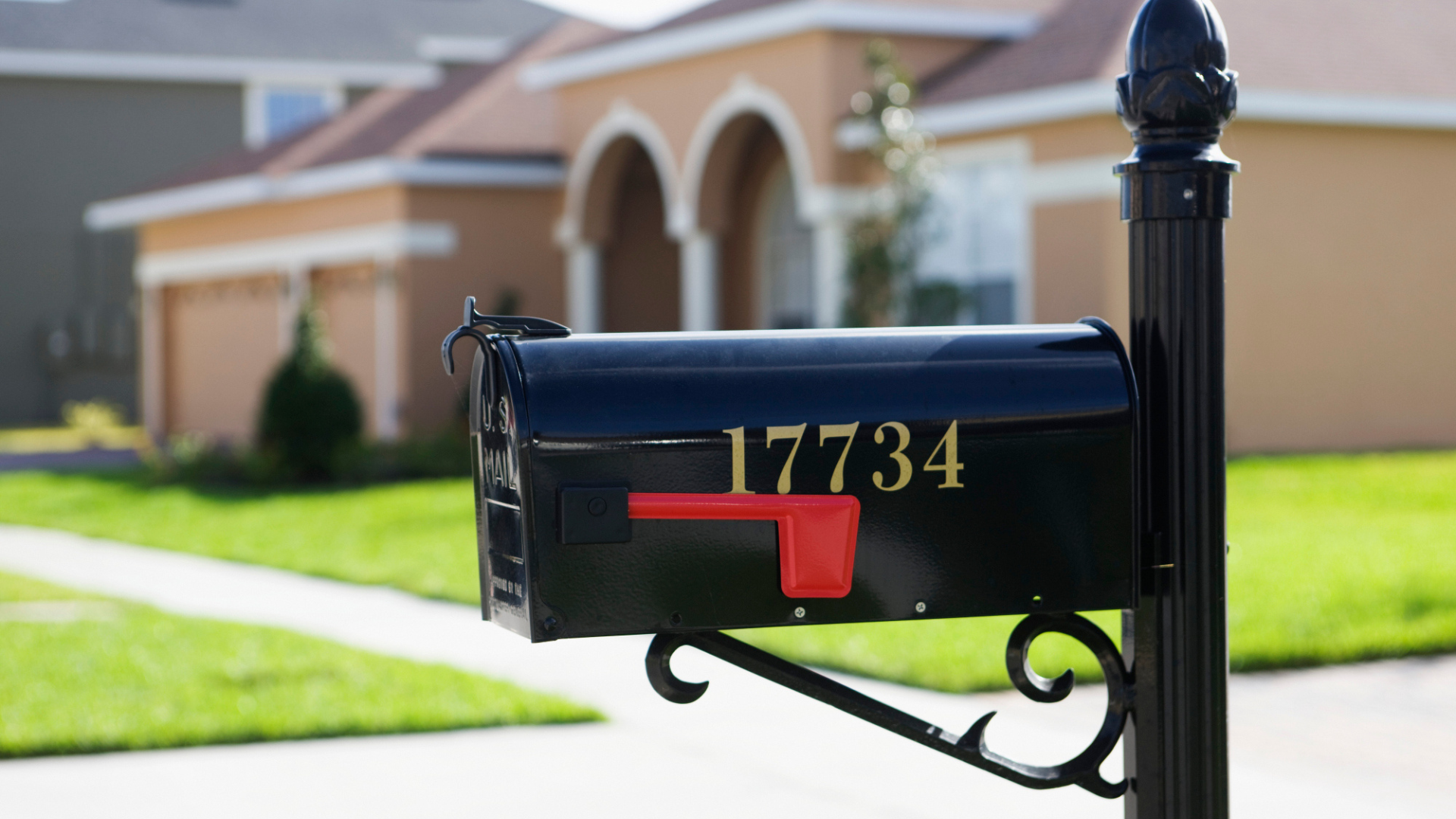 Black mailbox with gold house number