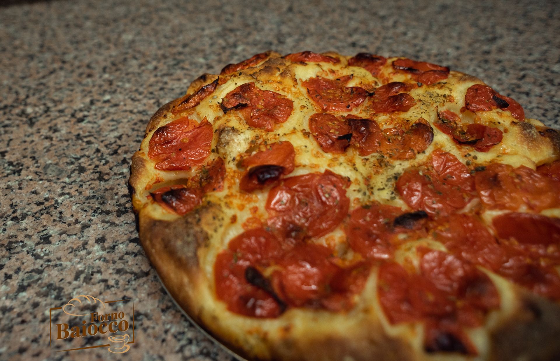 Una pizza al salame piccante su un piano di lavoro dalla superficie ruvida, immortalata in una foto ravvicinata dall'alto.