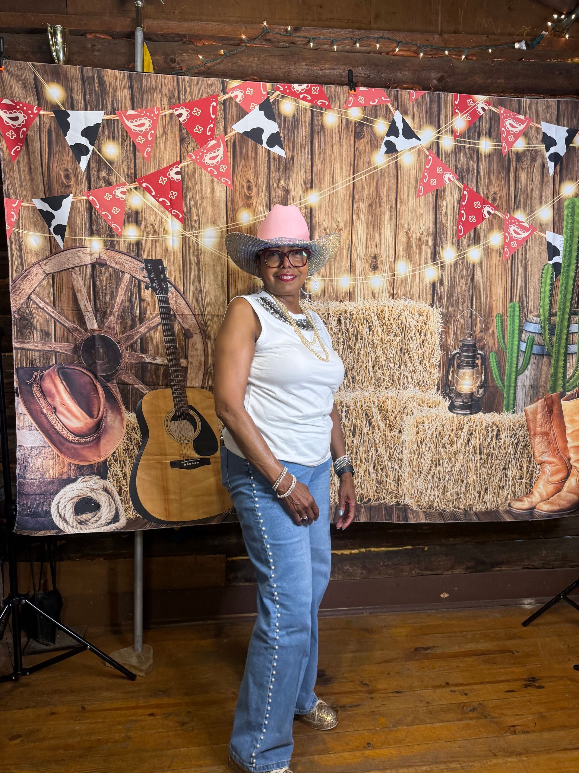 Eloise in cowboy attire in front of a cowboy facade.