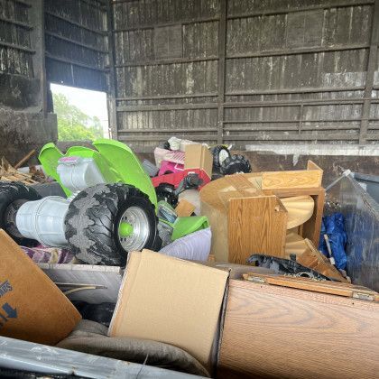 A pile of junk is sitting in a shed.