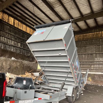 A dumpster trailer is parked inside of a building.