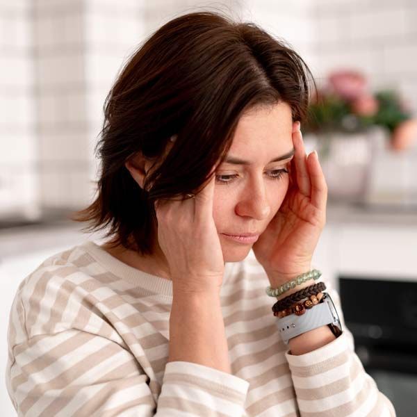 woman with neurological symptoms such as tingling, memory issues, and headaches