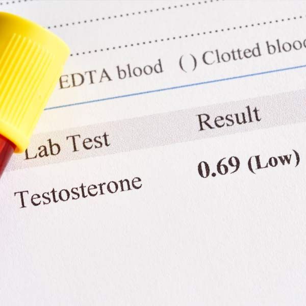 Lab test result showing low testosterone: 0.69, with a yellow pen tip nearby