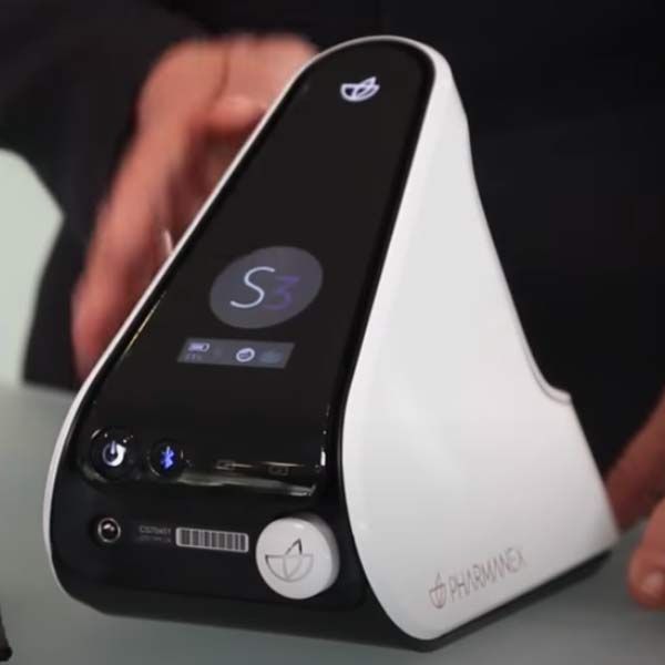 A person is holding an S3 Device for Antioxidant Scores device