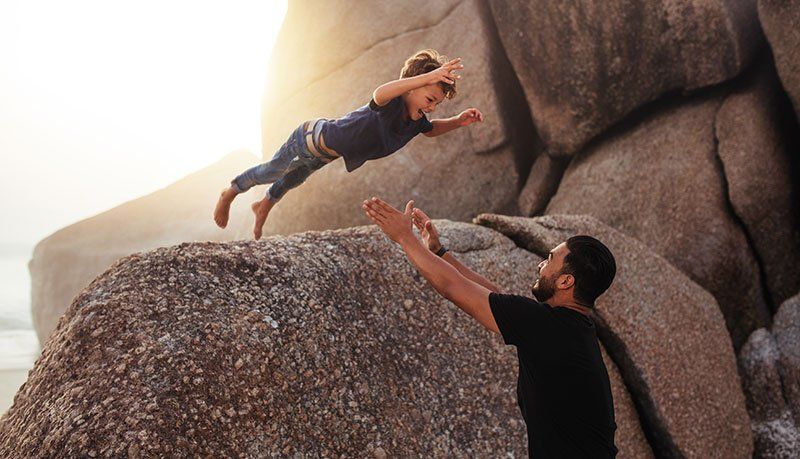 kid trusting dad while being tossed in the air