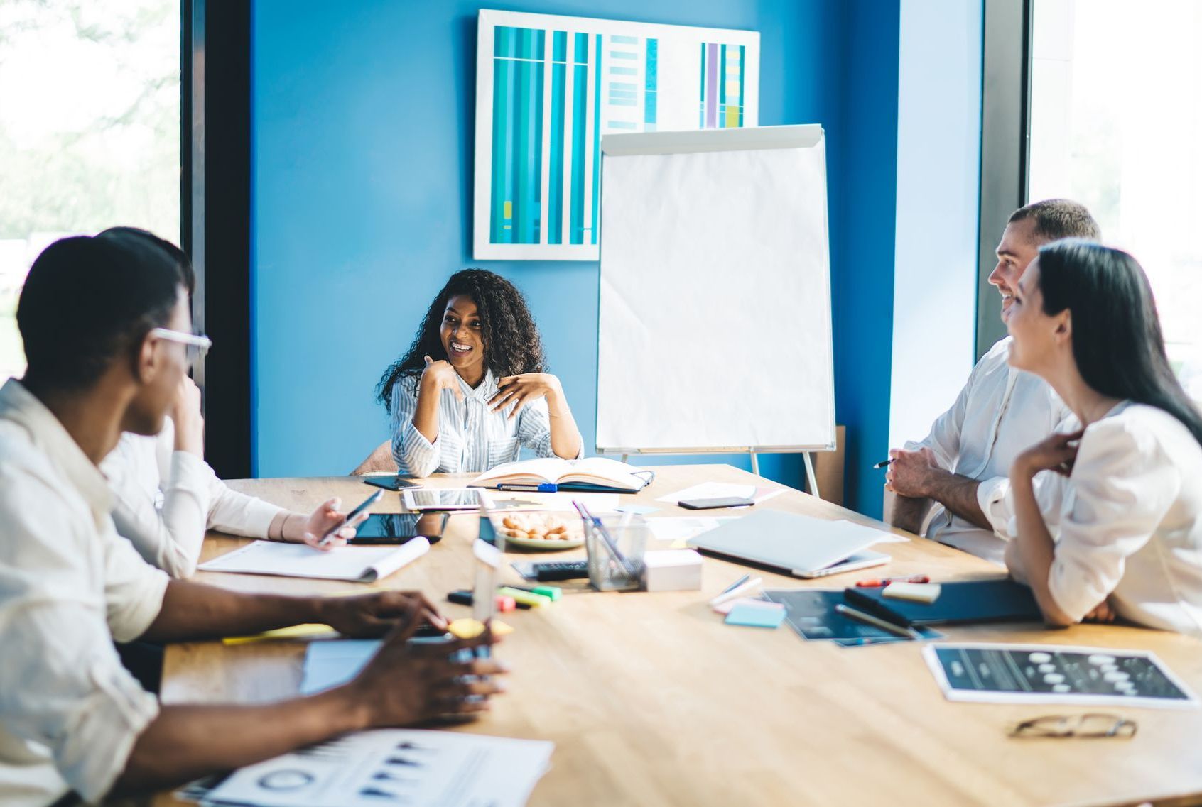 a group of people are sitting around a table having a meeting to discuss benefits administration platforms