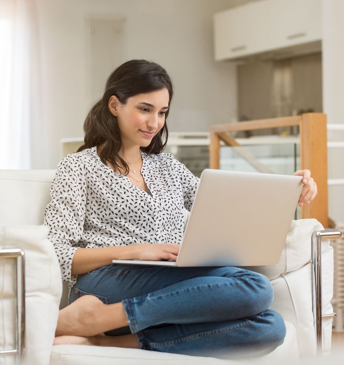A young woman is on her laptop looking for a new San Bernardino Employee Benefits Broker