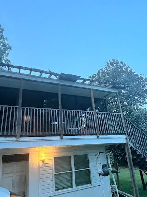 A house with a balcony and stairs on the second floor.