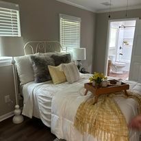 A bedroom with a bed and a tray on it.