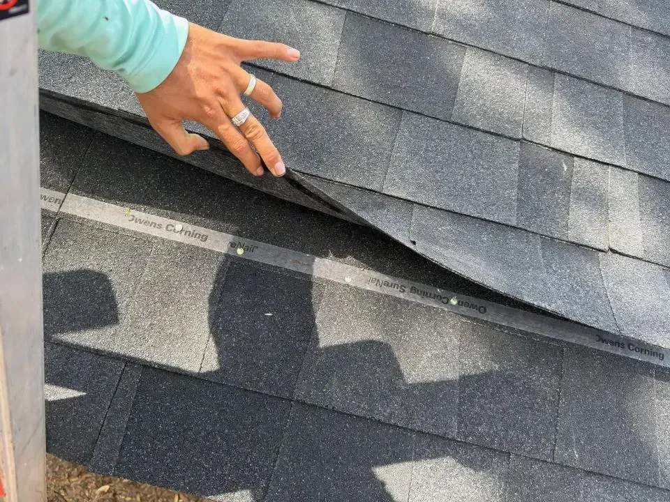 An aerial view of a house under construction with a black roof.