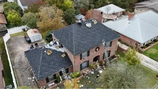 An aerial view of a gray metal roof with a skylight.
