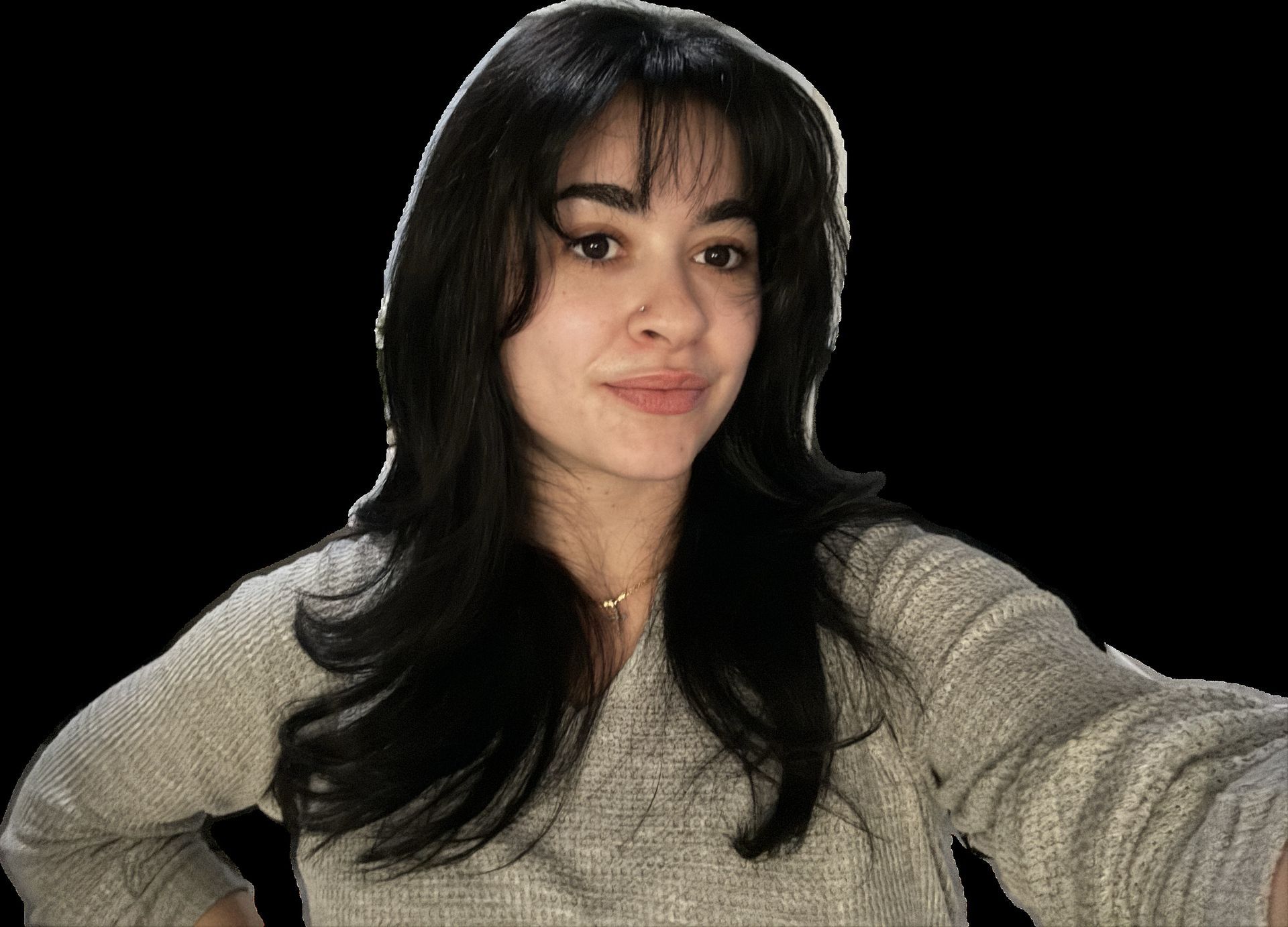Smiling woman with long wavy brown hair in a light blazer against a gray background