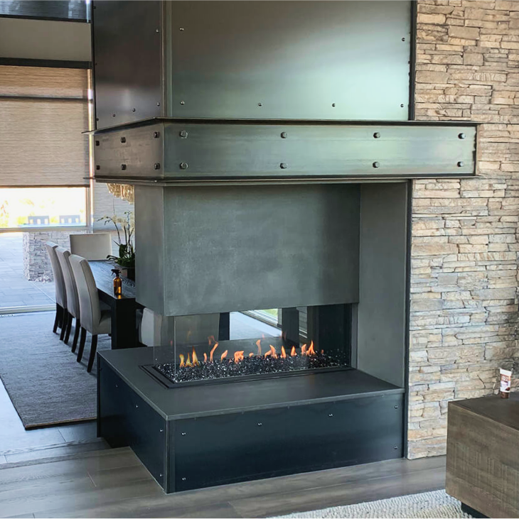 A fireplace in a living room with a brick wall