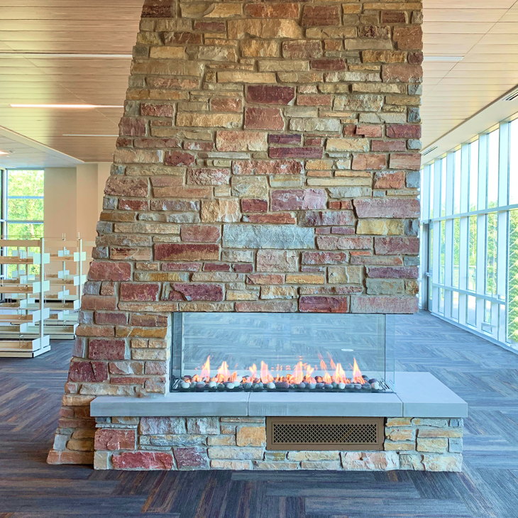 There is a fireplace in the middle of the room.