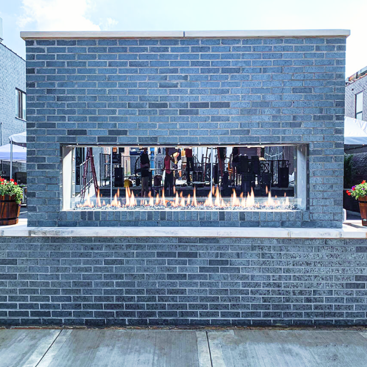 A brick wall with a fireplace inside of it